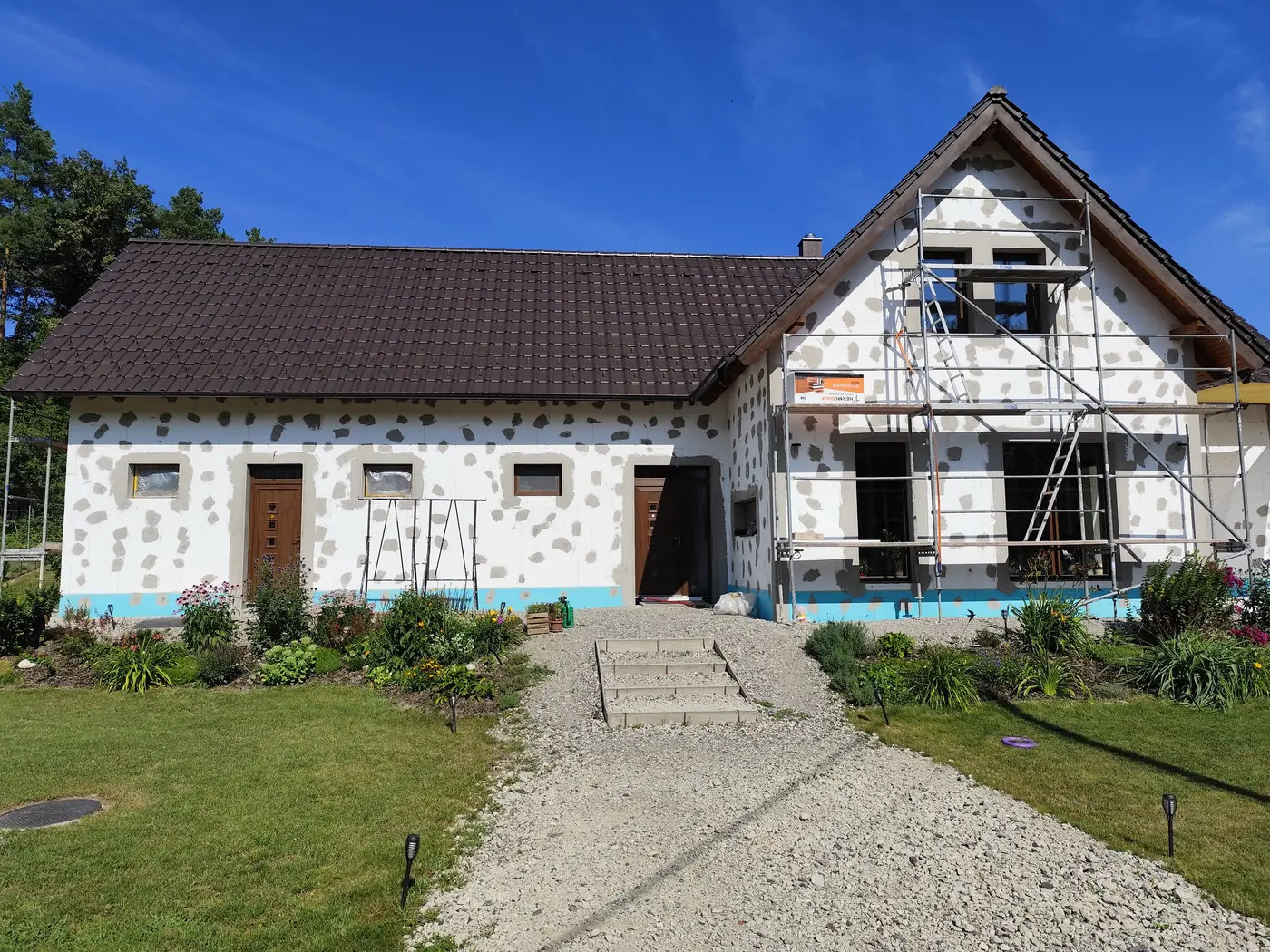 Szigetelt homlokzat hálózás közben, állvánnyal
